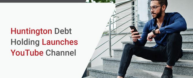 Middle eastern entrepreneur wear blue shirt, eyeglasses against office building sitting on stairs and look at mobile phone.